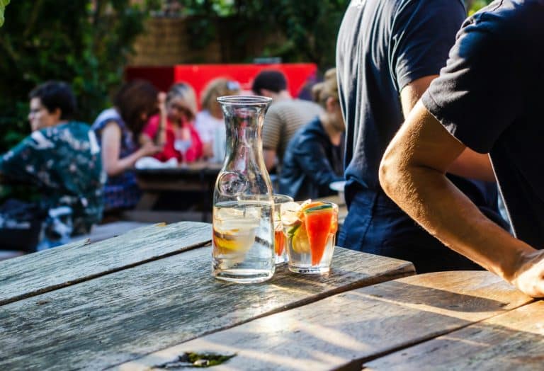 clear glass bottle across people